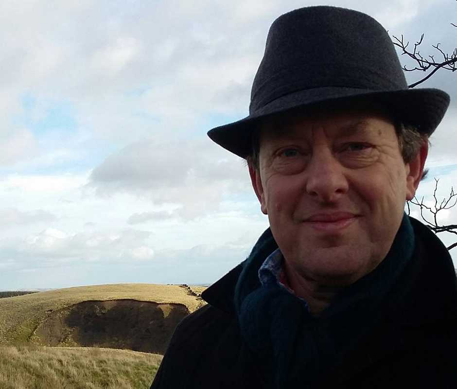 Image: Photograph of Adam Strickson in a hat